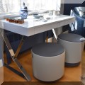 F06. White laquered desk with chrome legs. 30”h x 47”w x 24”d 